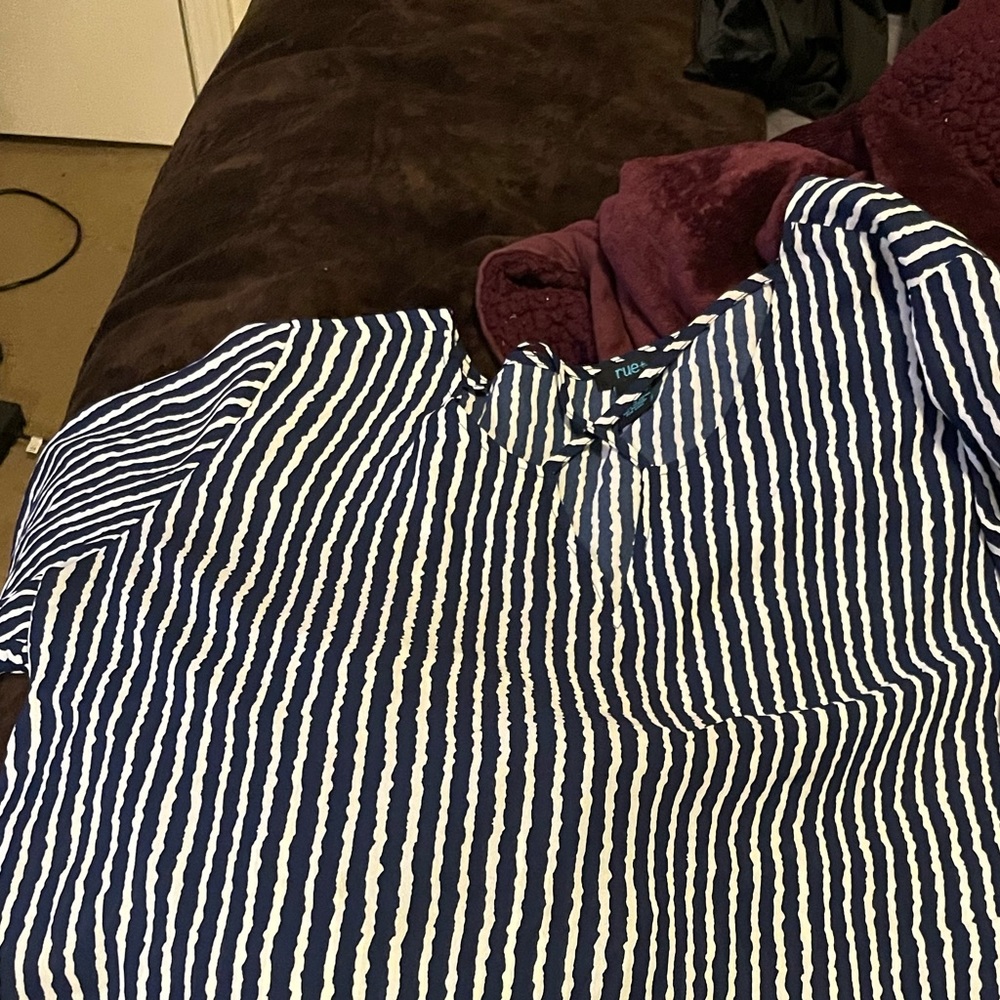 I have a size 2x it is by RUE21 it has dark blue and white pinstriped shirt.